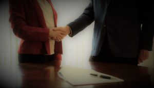 Two People Sign and Shake - M&A Advisors RoseBizInc